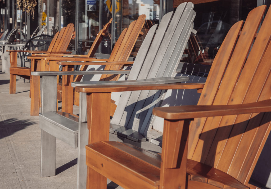 A row of adirondack chairs near cafe