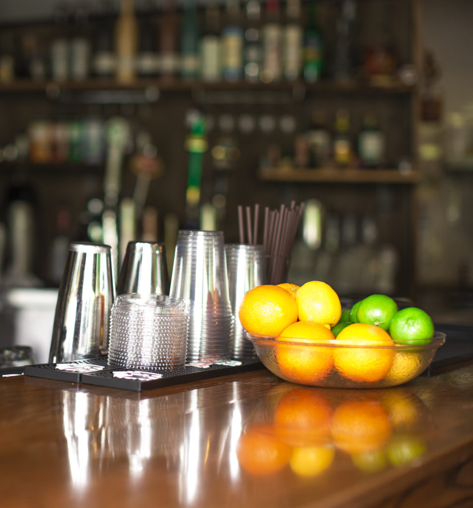 Fruit and mixing cups on a bar